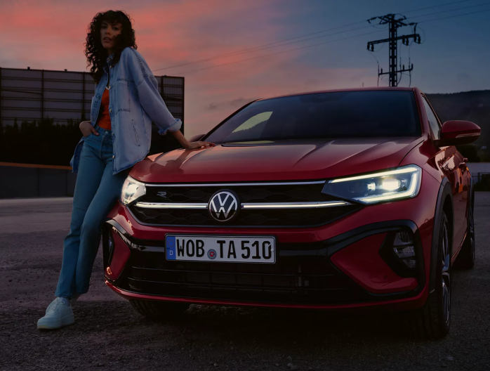 VW-taigo-exterior-red-front-woman-leans-against-car